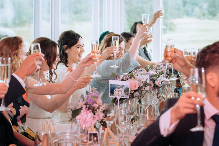 Brides And Their Guests Raising A Toast