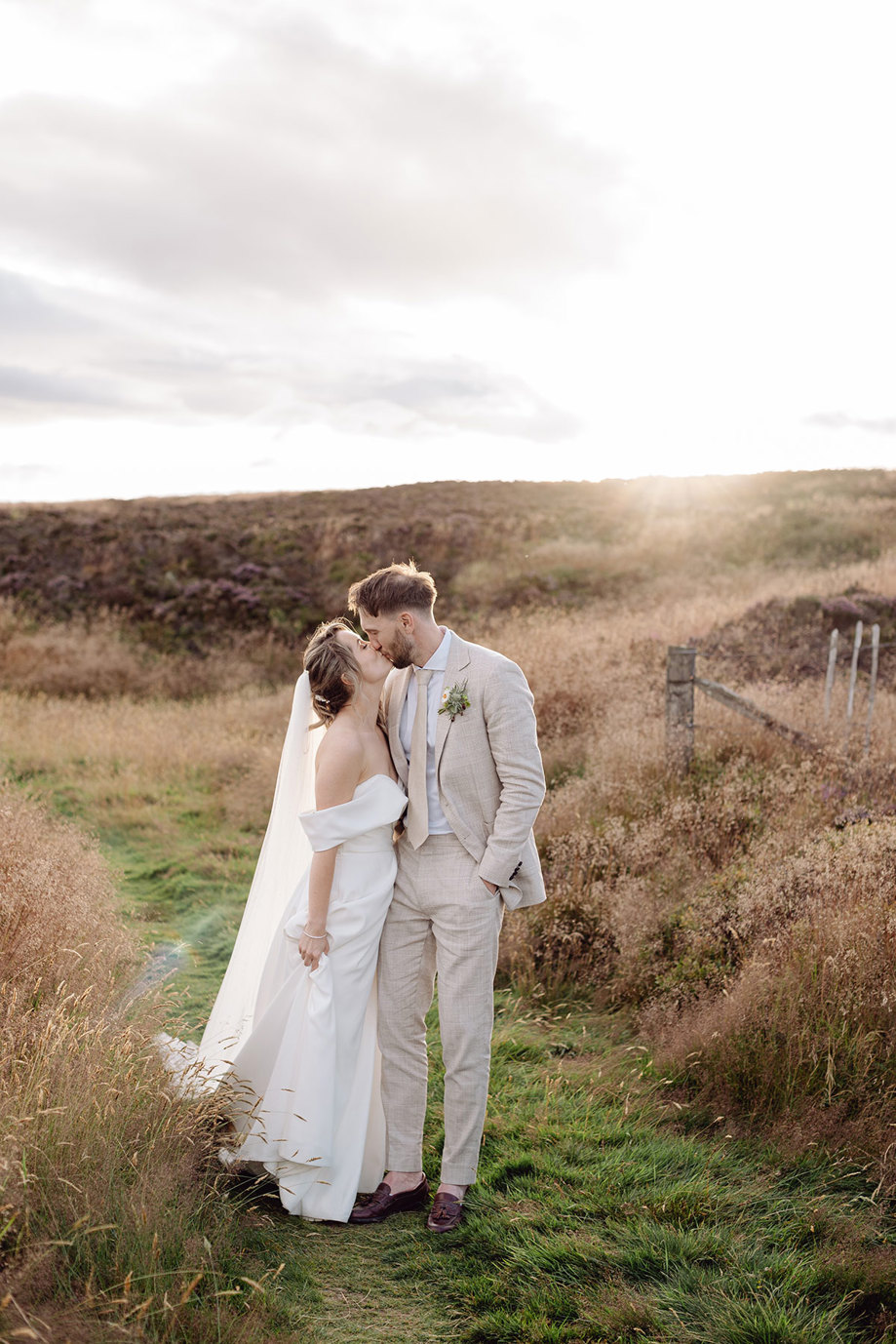 bride and groom kiss outdoors after wedding ceremony at drumtochty castle