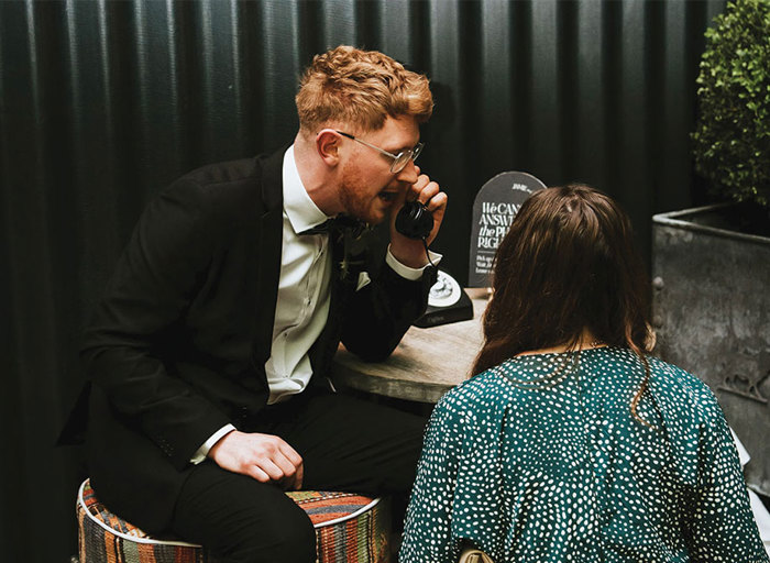 man in a suit on a vintage phone