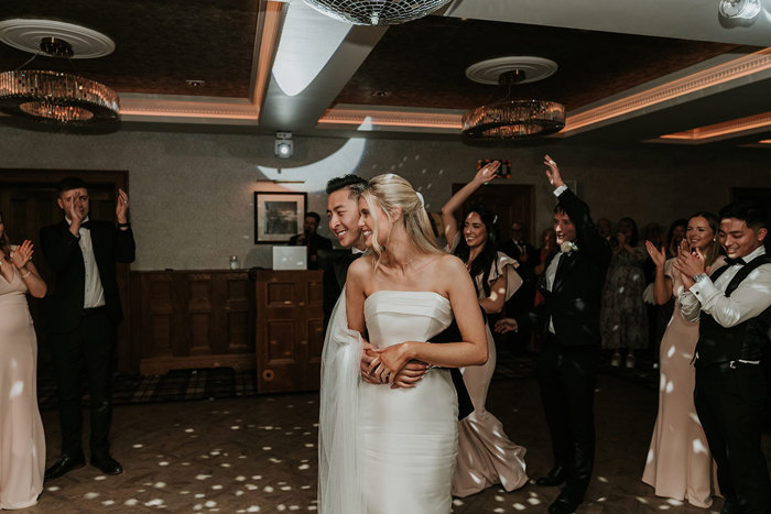 a bride and groom dancing during a wedding reception at Busby Hotel