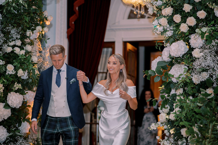 Bride and groom entering the ballroom hand in hand