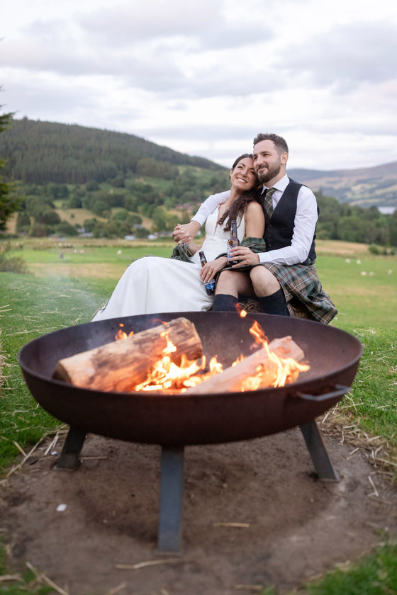 LochTay Wedding with Bride and Groom sitting at Fire Pit.