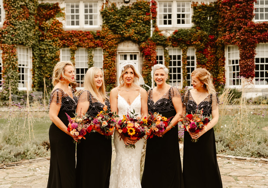 Bride and bridesmaids holding bright coloured bouquets at the rufflets house hotel