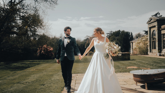 Holding hands in gardens of venue