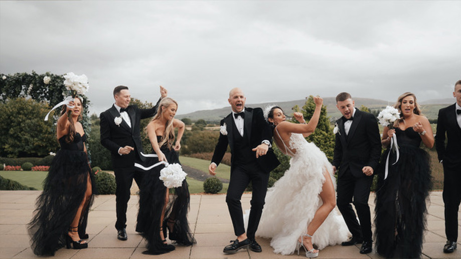 Bridal and groom parties dancing outside