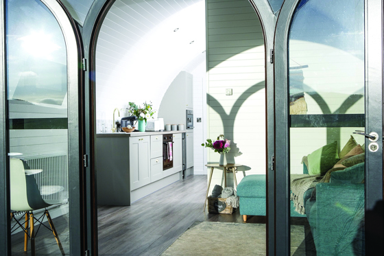 Image of inside glamping pod at Maycroft Retreat with shadows of door on the walls.