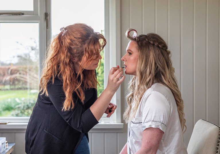 Jill Rowan Makeup applying lipstick