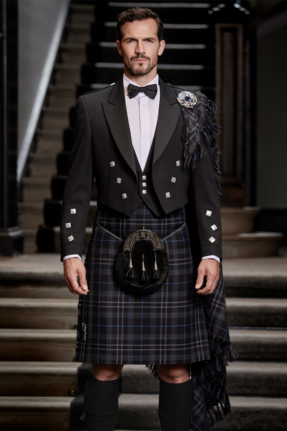 Groom wearing tuxedo-style kilt