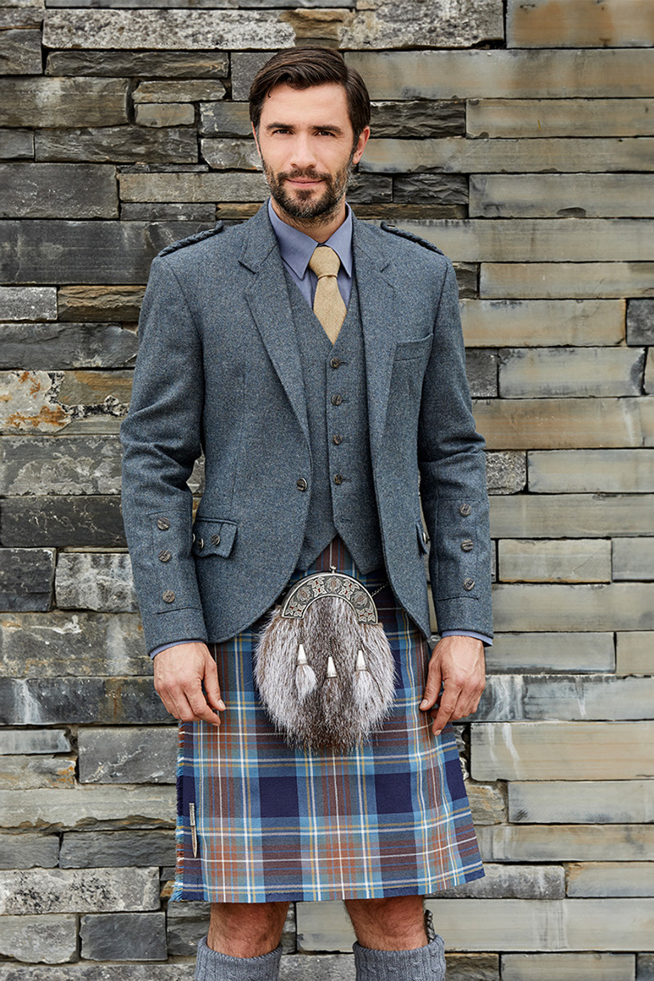 Groom wearing blue and brown kilt