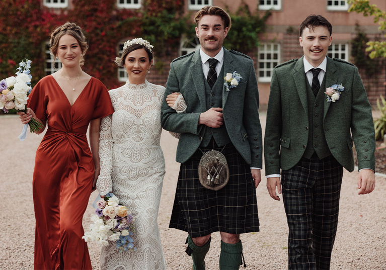 Bride, groom, maid of honour and best man walking