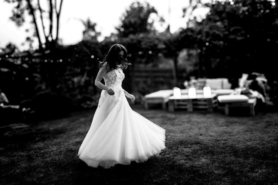 Bride twirls around outdoors in black and white