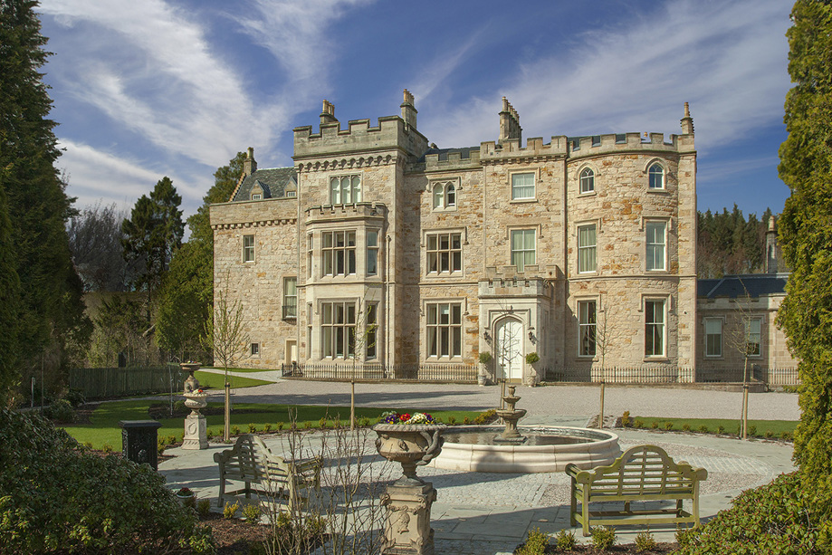 Exterior of Crossbasket Castle with fountain and benches in foreground