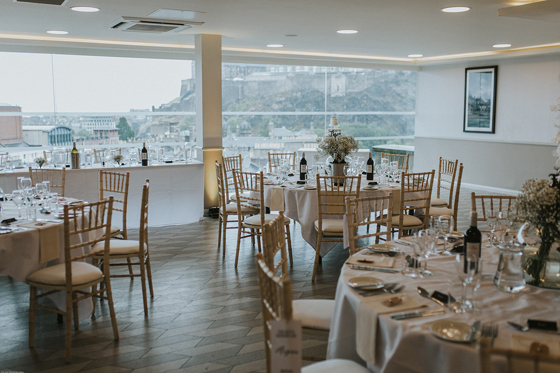 Round table wedding breakfast set up with wooden chiavari chairs