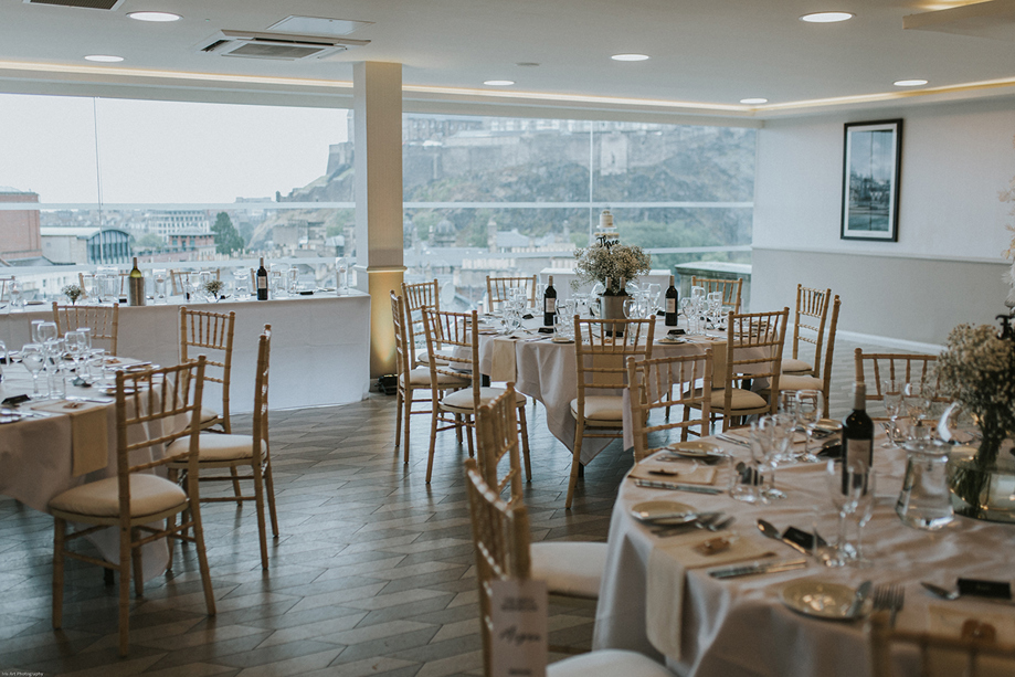 Round table wedding breakfast set up with wooden chiavari chairs