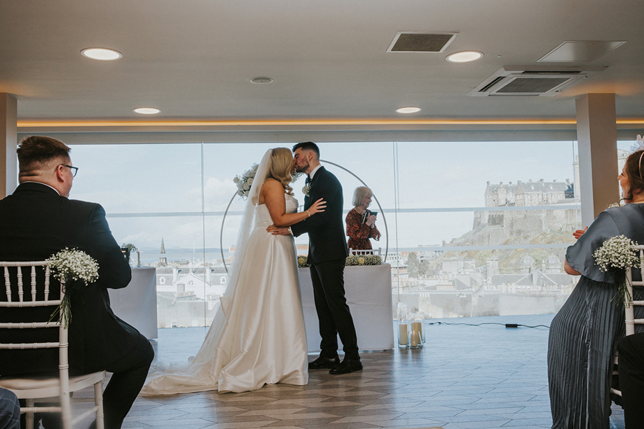 Bride and groom kiss at altar in SKYBar