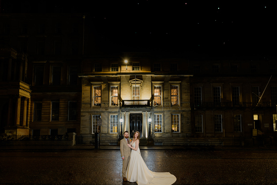 Bride and groom pose outside 1599 at the Royal College