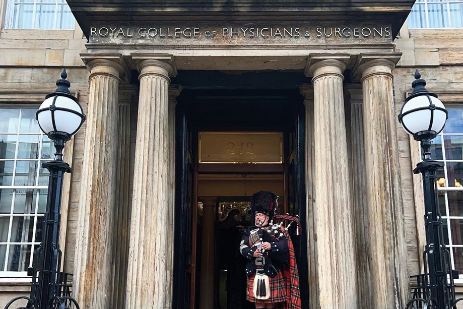 Bagpiper playing at main entrance to 1599 at the Royal College