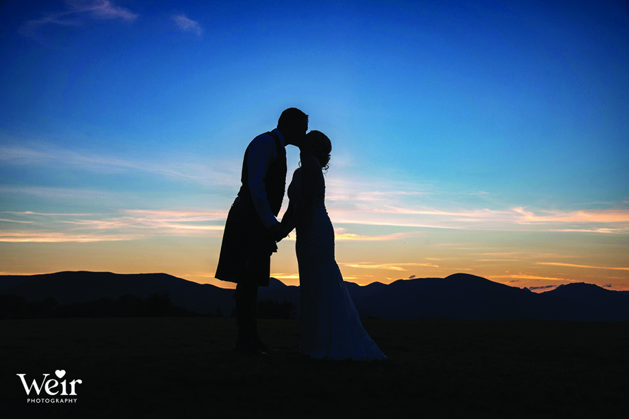 Bride and groom's shadows kiss at sunset by Weir Photography