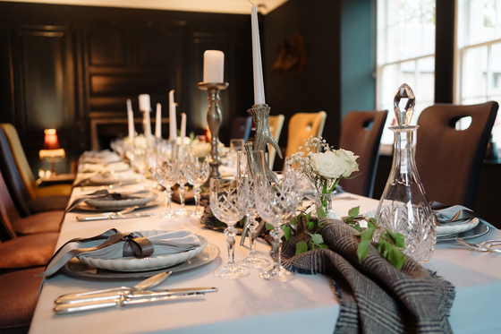 Wedding meal set up with tartan and gold antler candlesticks.