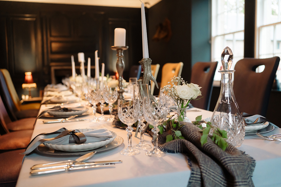 Wedding meal set up with tartan and gold antler candlesticks.