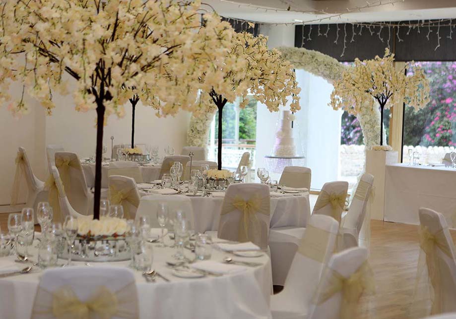 Meal set up with cream floral trees and cream chair bows