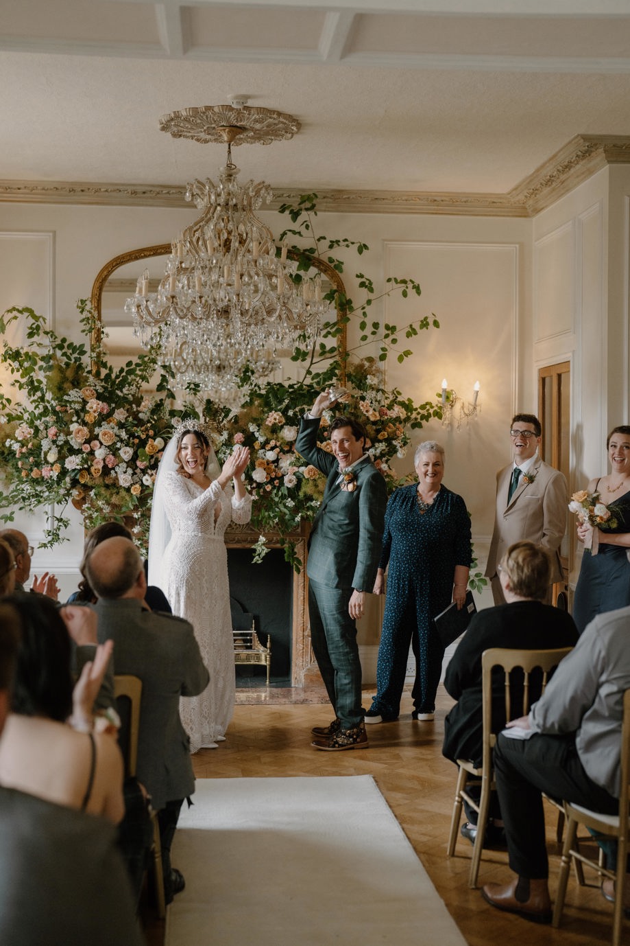 Bride and groom at the altar with flowers in background