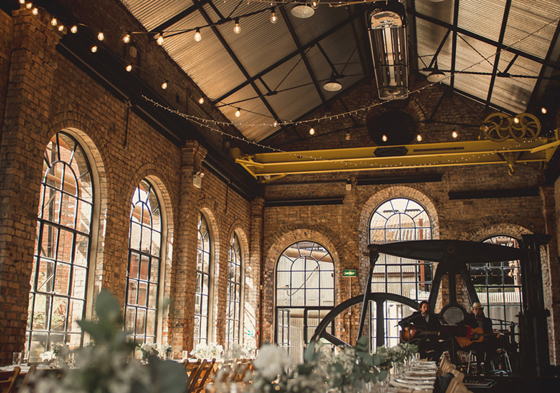 Interior of venue with arched windows and fairy lights