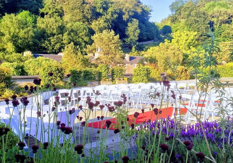 Outdoor ceremony with flowers in foreground