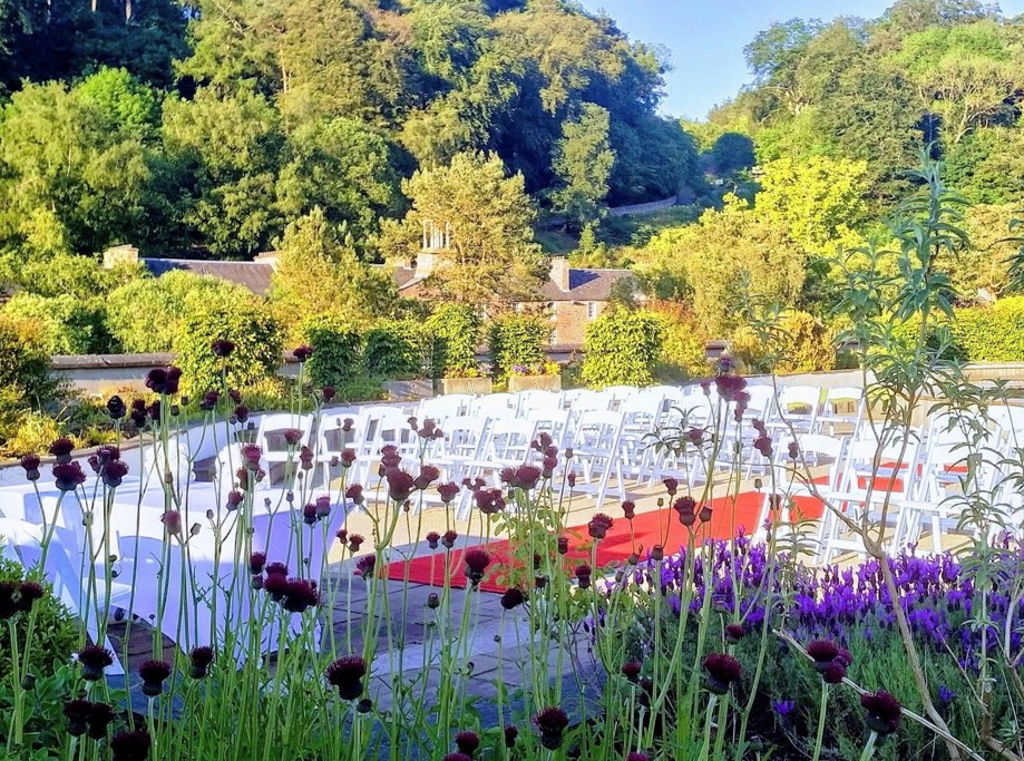 Outdoor ceremony with flowers in foreground