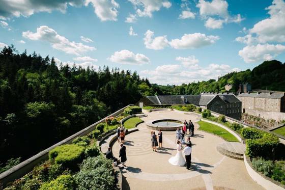 New Lanark Mill grounds with greenery in background