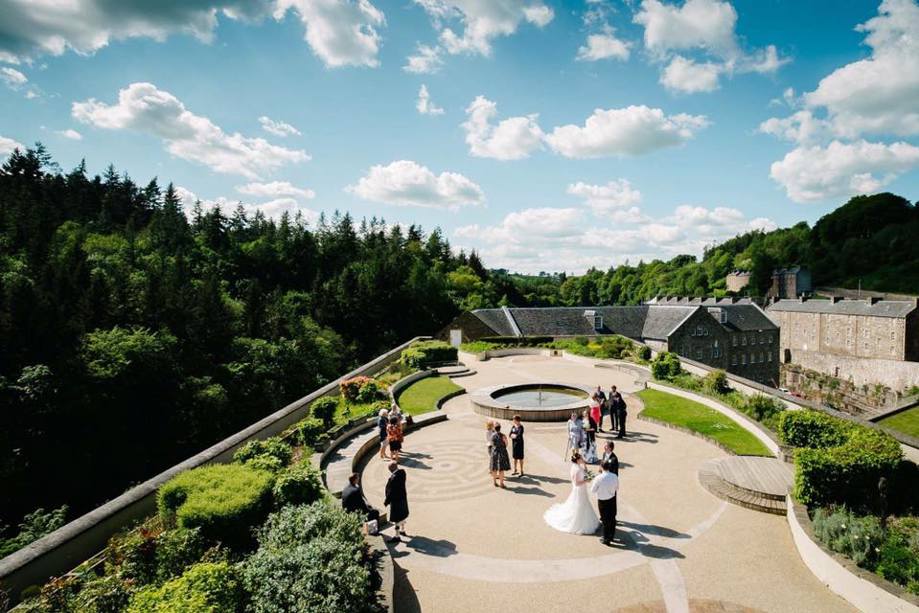 New Lanark Mill grounds with greenery in background