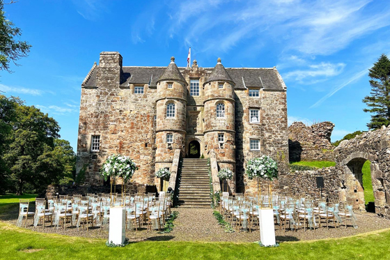 Rowallan Castle exterior with outdoor wedding set up.