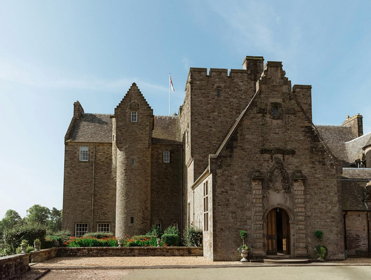 Side view of Rowallan Castle on a sunny day, displaying the building's baronial architecture.