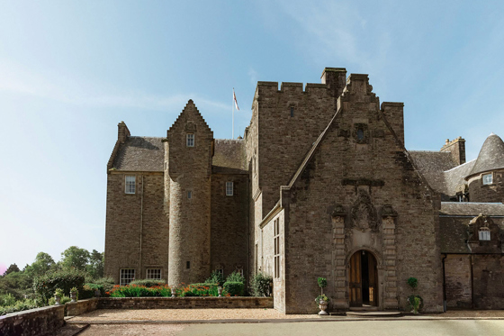 Side view of Rowallan Castle on a sunny day, displaying the building's baronial architecture.