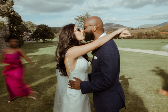 Bride and groom kiss on the grounds of Dougarie Estate