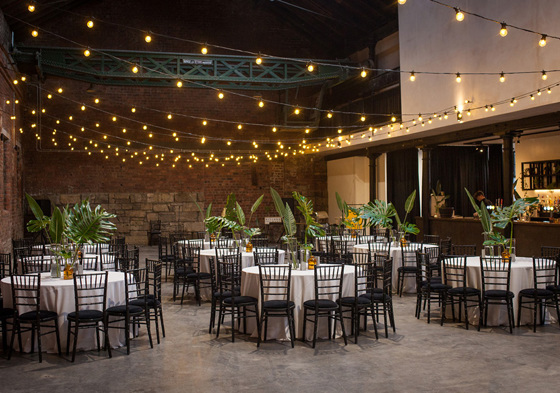 Fairy light and leaf decorated wedding meal set up