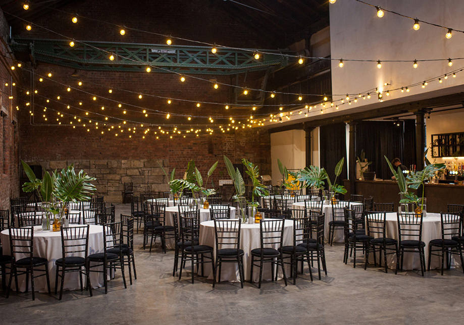 Fairy light and leaf decorated wedding meal set up