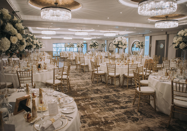 Wedding meal set up with bouquets of flowers on each table