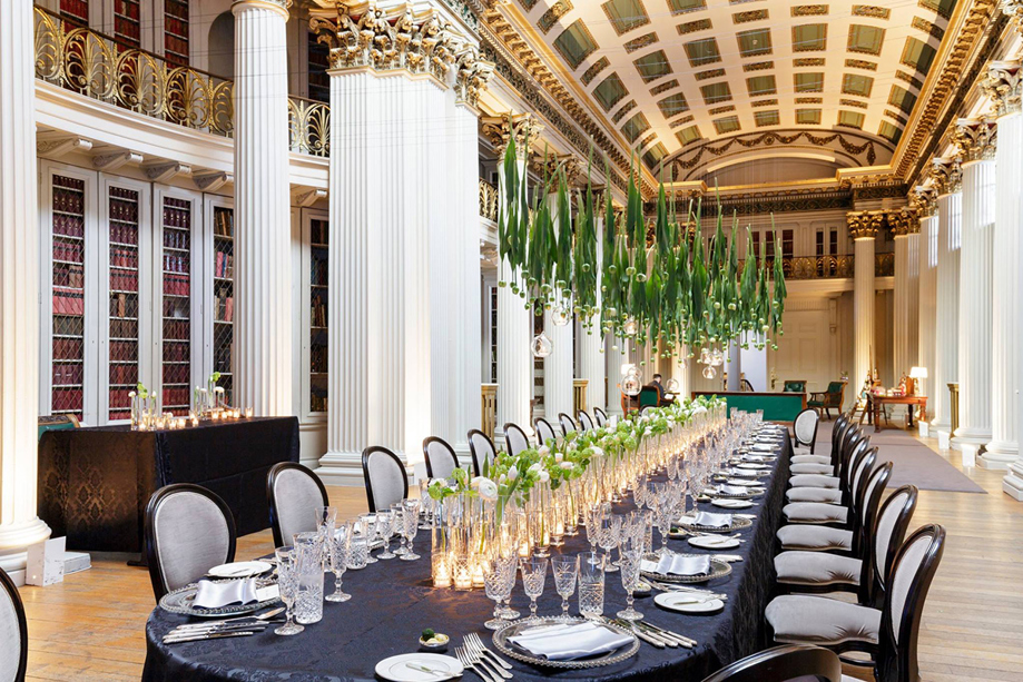 Long table decorated with hanging tulips and tulips with fairy lights lining the middle of the table