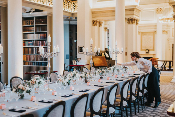 Long table decorated with pink and white flowers and silver candelabra's