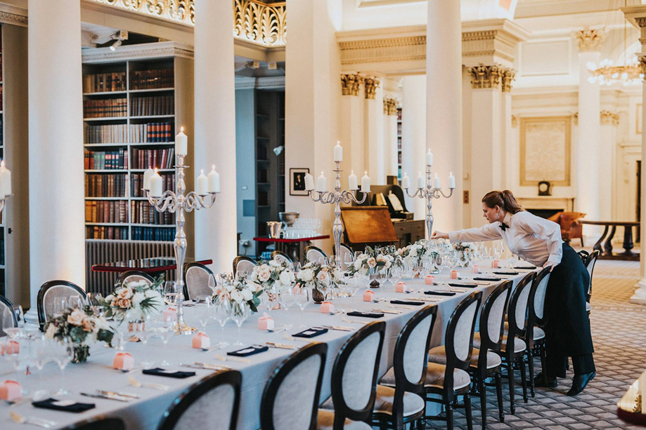 Long table decorated with pink and white flowers and silver candelabra's