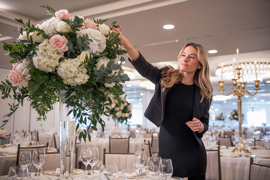 Staff member touching flowers to perfect the details 